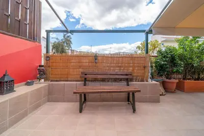 a wooden bench sitting on top of a patio at The HostMaster Ethnic Touch Feel Studio in Athens