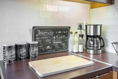 a kitchen counter with a coffee maker and a chalkboard at The HostMaster Ethnic Touch Feel Studio in Athens