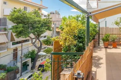an apartment balcony with a fence and trees at The HostMaster Ethnic Touch Feel Studio in Athens
