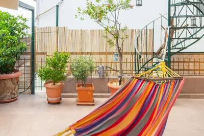 a colorful hammock in a room with potted plants at The HostMaster Ethnic Touch Feel Studio in Athens