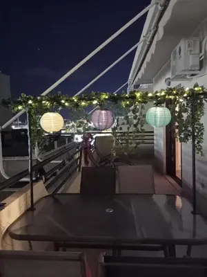 a table on the deck of a boat at night at Myilios Leisure Piraeus by Ilios Company in Piraeus