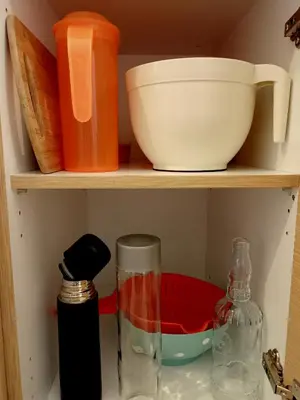a shelf with bowls and other kitchen items on it at Myilios Leisure Piraeus by Ilios Company in Piraeus
