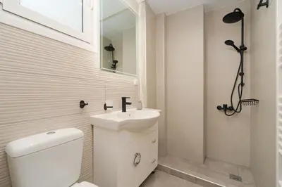 a white bathroom with a toilet and a sink at Luxury Penthouse Maisonette Nearby Acropolis in Athens