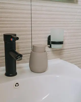 a bathroom with a faucet and two cups at Luxury Penthouse Maisonette Nearby Acropolis in Athens
