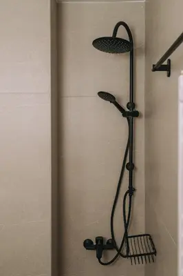 a shower with a black shower head in a bathroom at Luxury Penthouse Maisonette Nearby Acropolis in Athens