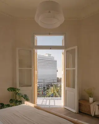 a bedroom with a window with a view of a building at Casa Tao in Athens