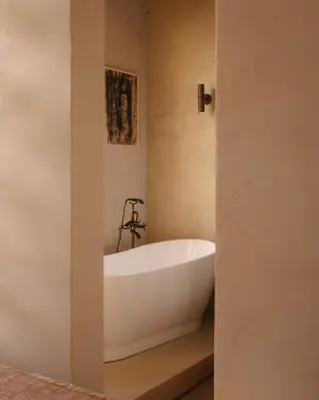 a white bath tub sitting in a bathroom at Casa Tao in Athens