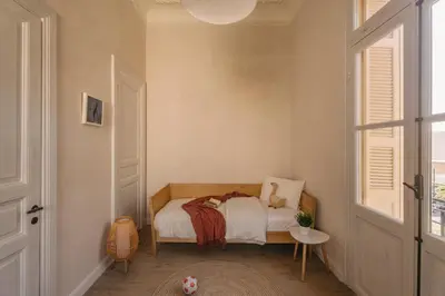 a small bedroom with a bed and a window at Casa Tao in Athens