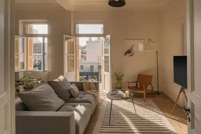 a living room with a couch and some windows at Casa Tao in Athens
