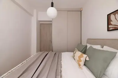 a bedroom with a bed with pillows on it at Koukaki 2BR Apartment by UPSTREET in Athens