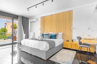 a bedroom with a large bed and a desk and a deskablish at The HostMaster Roofgarden Urban Bliss in Athens