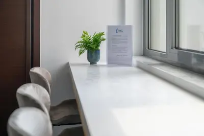 a potted plant sitting on a table next to a window at The HostMaster Roofgarden Urban Bliss in Athens