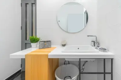 a bathroom with a sink and a mirror at The HostMaster Roofgarden Urban Bliss in Athens