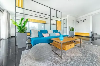 a living room with a blue couch and a table at The HostMaster Roofgarden Urban Bliss in Athens