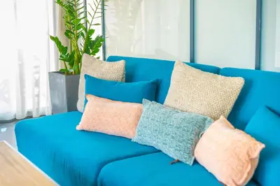 a blue couch with pillows on it at The HostMaster Roofgarden Urban Bliss in Athens