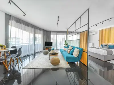 a living room with a blue couch and a bed at The HostMaster Roofgarden Urban Bliss in Athens