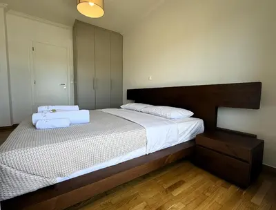 a bedroom with a bed with two towels on it at Piraeus center sea view apartment in Piraeus