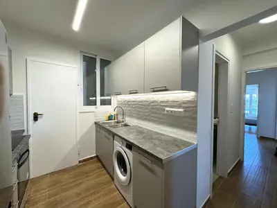 a kitchen with a sink and a washing machine at Piraeus center sea view apartment in Piraeus