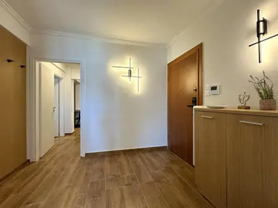an empty hallway with two crosses on the wall at Piraeus center sea view apartment in Piraeus