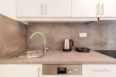 a kitchen counter with a sink and a coffee maker at The HostMaster Ethereal Scene in Athens
