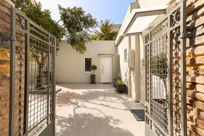 a gate to a house with a stone wall at The HostMaster Aethereal Style in Athens
