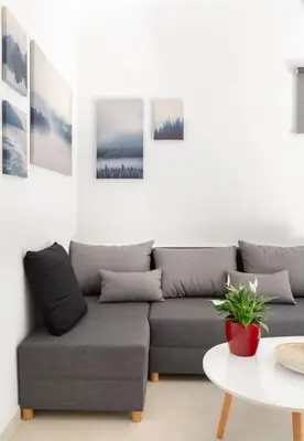 a living room with a couch and a table at The HostMaster Aethereal Style in Athens