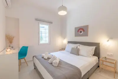 a bedroom with a bed with two towels on it at The HostMaster Aethereal Style in Athens