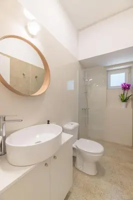 a bathroom with a sink and a toilet and a mirror at The HostMaster Aethereal Style in Athens