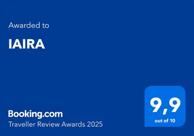 a blue square with the text awarded to kira travelling review awards at IAIRA in Athens