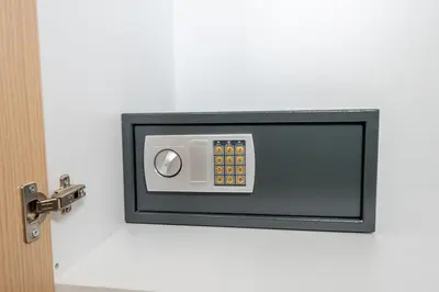 a small television attached to a white wall at IAIRA in Athens