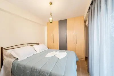 a bedroom with a bed with two towels on it at IAIRA in Athens
