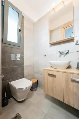 a bathroom with a toilet and a sink at IAIRA in Athens