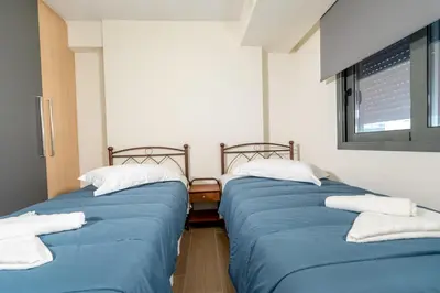 two beds sitting next to each other in a room at IAIRA in Athens