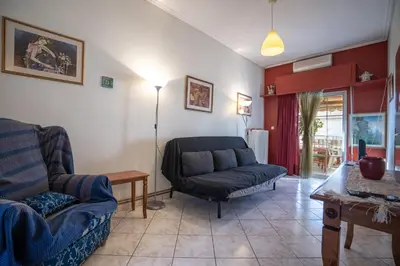 a living room with a couch and a chair at N kosmos metro st 1 bedroom 4 pers flat by MPS in Athens