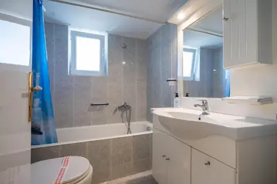 a bathroom with a sink and a toilet and a tub at N kosmos metro st 1 bedroom 4 pers flat by MPS in Athens