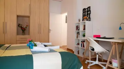 a room with a bed and a desk and a table at Cozy Apartment in Athens Center in Athens