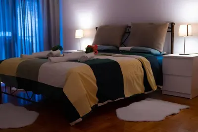 a bedroom with a large bed with pillows on it at Cozy Apartment in Athens Center in Athens