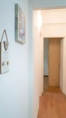 a hallway with a door and a sign on a wall at Cozy Apartment in Athens Center in Athens