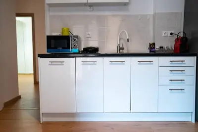 a kitchen with white cabinets and a microwave at Cozy Apartment in Athens Center in Athens