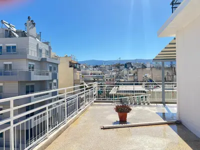 a balcony with a view of a city at Cozy apartment with big veranda near Athens centre and metro tram in Athens