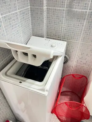 a washer and dryer sitting inside of a refrigerator at Cozy apartment with big veranda near Athens centre and metro tram in Athens