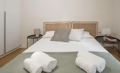 a bedroom with a large white bed with two tables at Athens Secret Gem in Athens