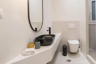 a bathroom with a black sink and a toilet at Athens Secret Gem in Athens