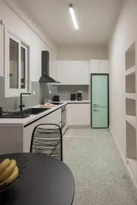 a kitchen with a table and a green refrigerator at Athens Secret Gem in Athens