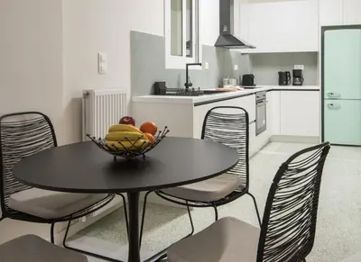 a kitchen with a table with a bowl of fruit on it at Athens Secret Gem in Athens