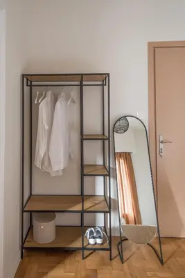 a wardrobe with shelves and a mirror in a room at Athens Secret Gem in Athens