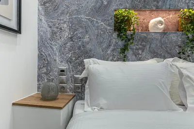 a bedroom with a bed with white pillows at Stylish Living-Avra in Athens