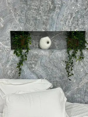 a white vase sitting on a wall with plants at Stylish Living-Avra in Athens