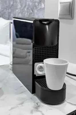 a white coffee cup sitting inside of a microwave at Stylish Living-Avra in Athens