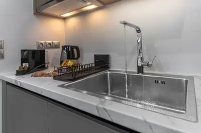 a kitchen with a stainless steel sink with a faucet at Stylish Living-Avra in Athens